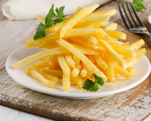 French fries on  wooden board