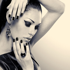 Woman with black nails and with stylish bijouterie