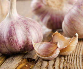 garlic whole and cloves on  wooden board