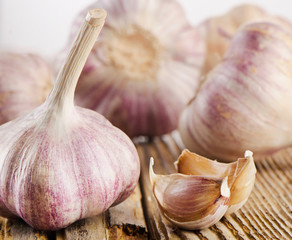 garlic whole and cloves on  a wooden table