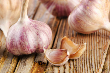 garlic whole and cloves on  a wooden board