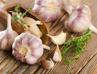garlic whole and cloves on a wooden background