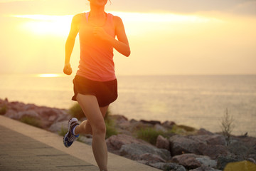 woman runner athlete running at seaside