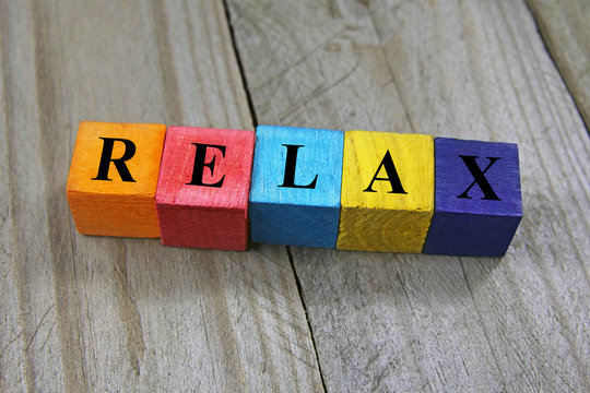 concept of relax word on wooden colorful cubes