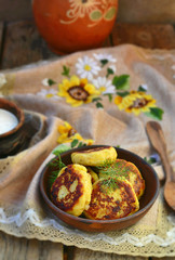 potato patties with fried  bacon  and onions.