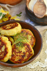 potato patties with fried  bacon  and onions.