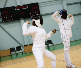Two women fencers on a training