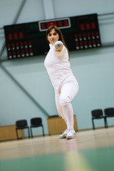 Young woman fencer with epee