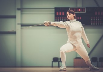 Young woman fencer with epee
