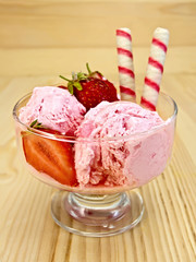 Ice cream strawberry in glass goblet on board