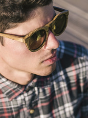Model man portrait with wooden sunglasses