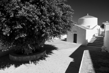 Typical feature from greek country, religious architecture. Black and white picture of small chapel.