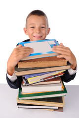 Schoolboy with huge stack of books