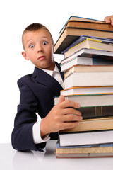 surprised schoolboy with huge stack of books