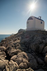 Typical greece. Small chapel on the rock above sea level.