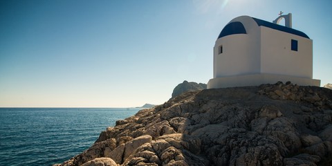 Typical greece. Small chapel on the rock above sea level.