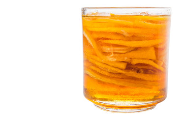 Home remedy of lemon slices and honey in a glass jar over white 