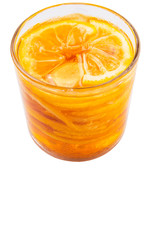 Home remedy of lemon slices and honey in a glass jar over white 