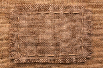 Frame of burlap, lies on a background of burlap