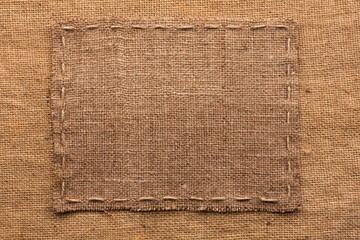 Frame of burlap, lies on a background of burlap