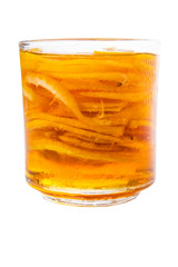 Home remedy of lemon slices and honey in a glass jar over white 