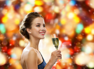 smiling woman holding glass of sparkling wine