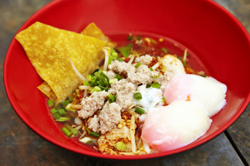 close up thai spicy pork noodle in red cup
