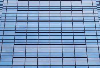 Fototapeta na wymiar Abstract texture of blue glass modern office building background