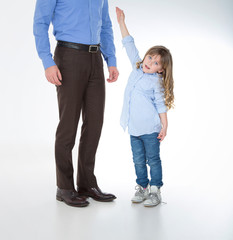 man standing close to his daughter