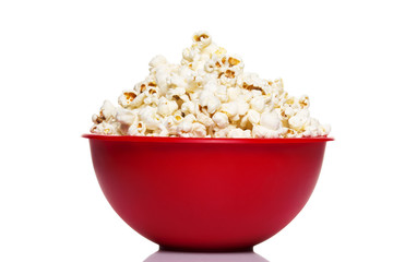 Red bowl with popcorn isolated on white - obrazy, fototapety, plakaty