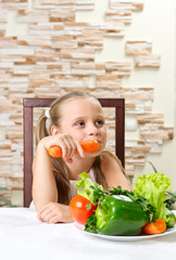 Little girl eat vegetables