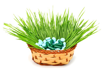 Pills, tablets and wheat grass in the basket