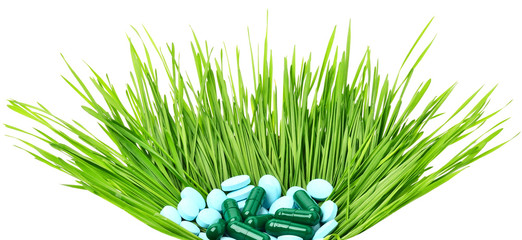 Pills, tablets and wheat grass in the basket