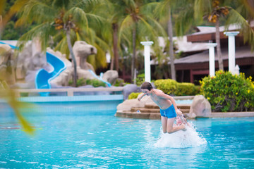 Boy jumping in swimming pool