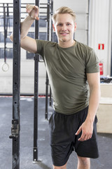 Smiling man in workout outfit at the fitness gym