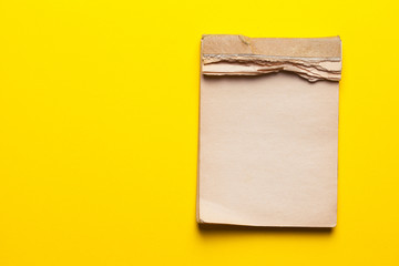 old notebook on yellow background