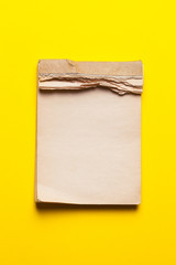 old notebook on yellow background