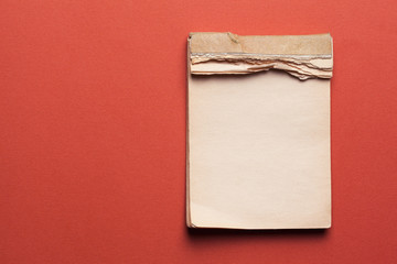 old notebook on red background
