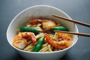 hot noodles with shrimps on a black background