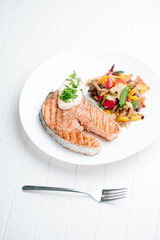 Grilled Salmon with Fresh vegetables on white background