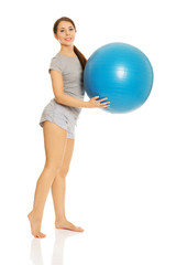 Woman holding fitness ball