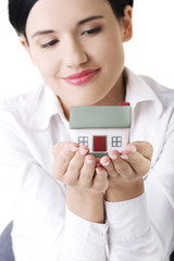 Woman holding a house model