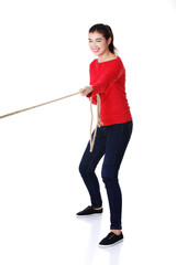 Young woman pulling a rope