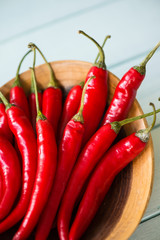 Fresh chilli in wooden bowl on table