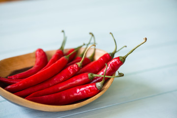 Fresh chilli in wooden bowl on table