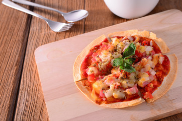 Tortilla pizza with mozzarella cheese, pepper, and basil on the