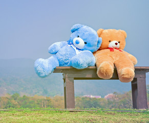 big teddy bears  sitting on wood chair