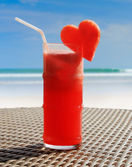 Fruity cocktail on a beach table