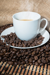 cappuccino with  smoke and roasted coffee beans