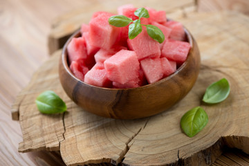 Watermelon cubes in a wooden bowl, horizontal shot